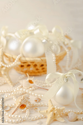 Christmas and New Year. Christmas-tree white toys in a marine style, seashells stones and starfish.