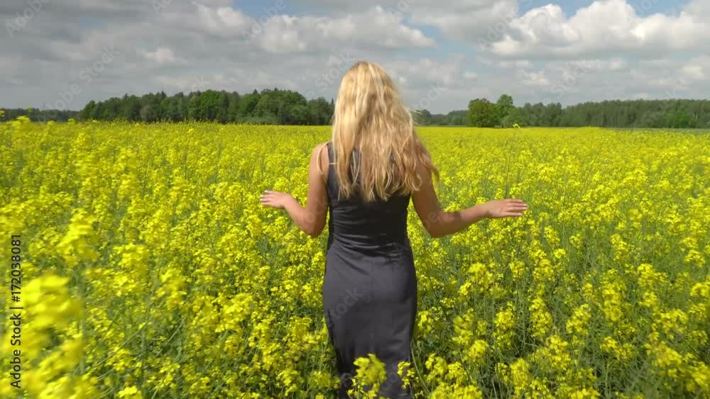 young blonde woman posing in beautiful rapeseed field young blonde woman posing in beautiful rapeseed field