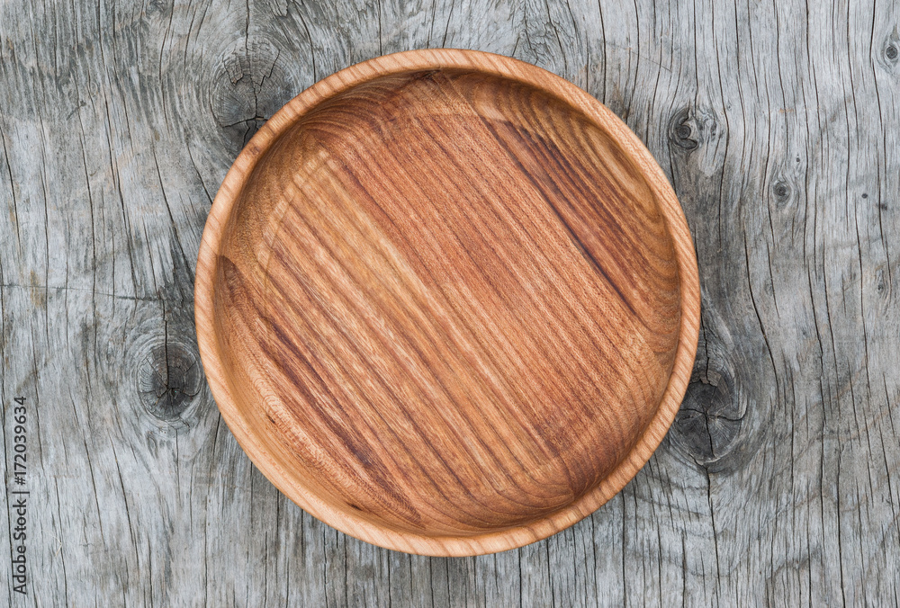 Round cutting Board natural wood on the old wooden table vintage, closeup, top view Round cutting Board natural wood on the old wooden table vintage, closeup, top view