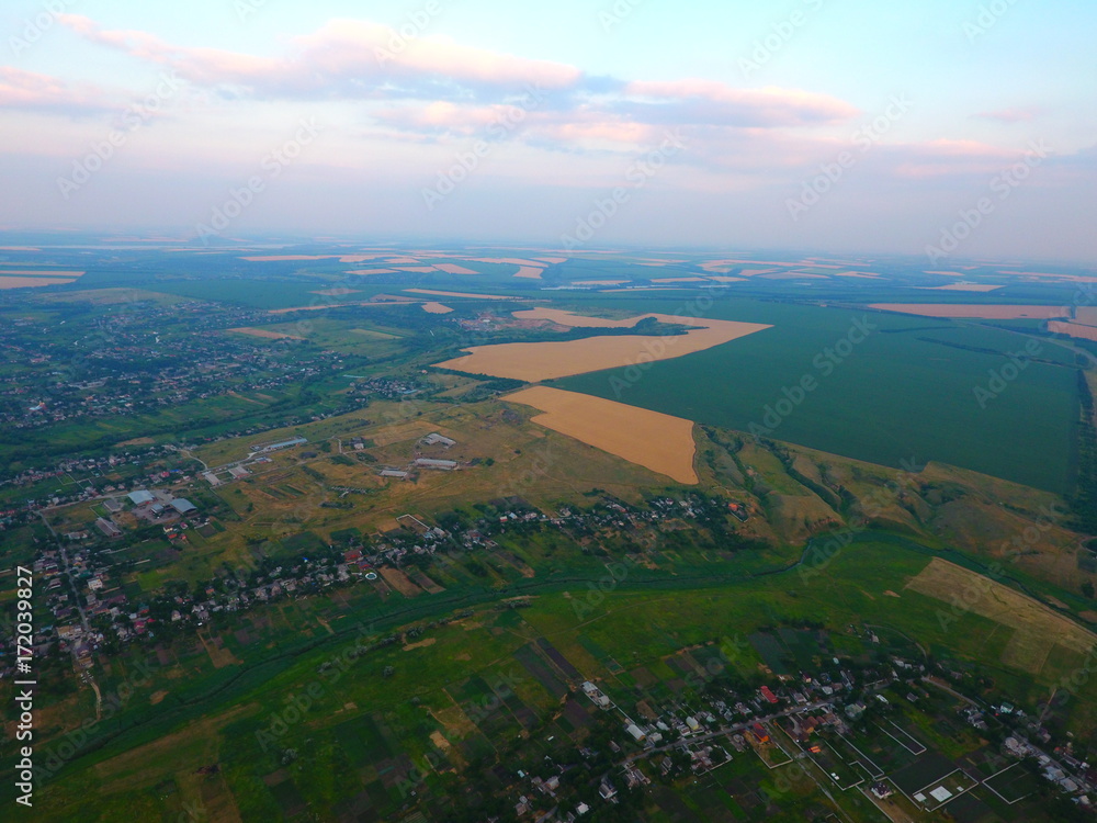 Aerial view of beautiful village, houses, roads. Sky, clouds. Aerial view of beautiful village, houses, roads. Sky, clouds.