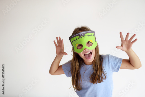 The girl plays in a self-made mask of Frankenstein