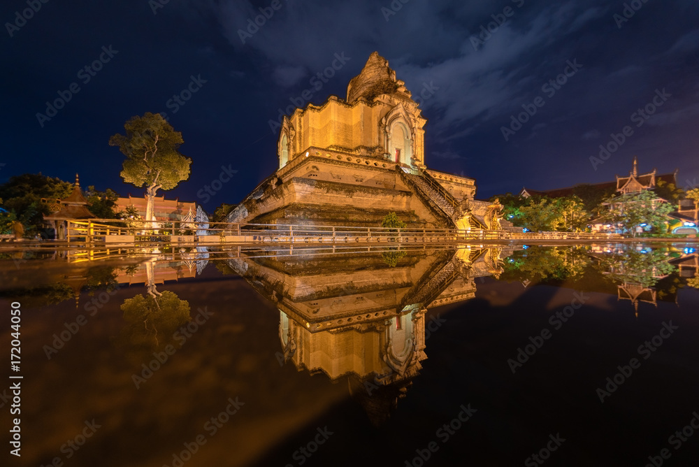 Giant pagoda reflecting in water, Wat Chedi Lung  oldest temple in Chiang Mai ,Thailand.