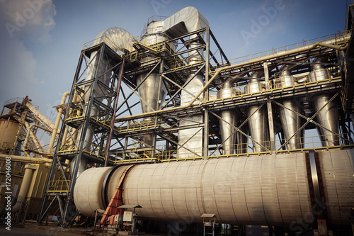 Factory view of particle board products: sky, conveyor, drum dryer, cyclone, silos, steel structure