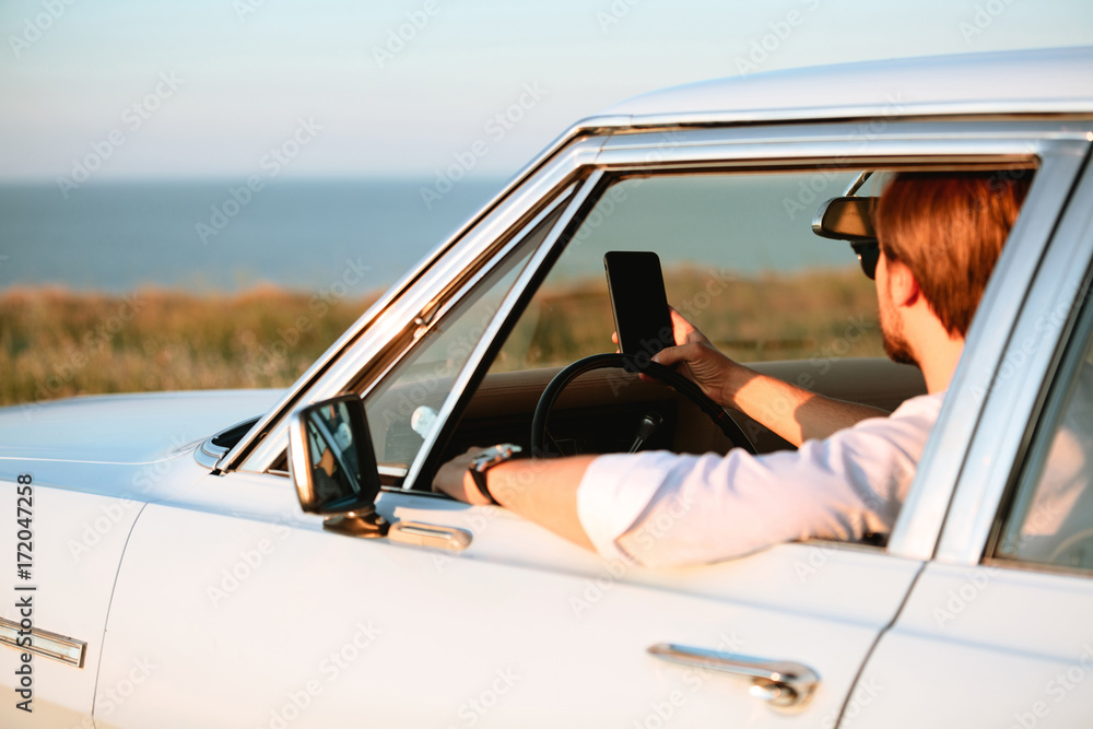 Side view of Man sitting in retro car