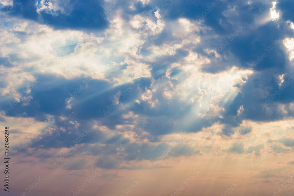 rays of the sun make their way through dramatic clouds