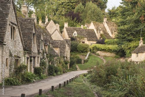 Medieval houses in Arlington Row in Cotswolds countryside landscape in England