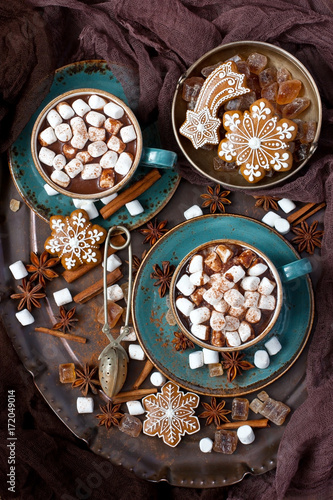 Cups of hot chocolate with marshmallows and gingerbread cookies on wooden background, christmas concept