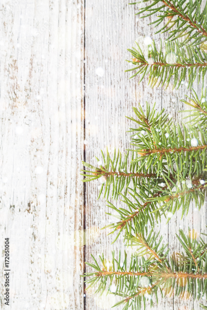 Christmas wooden background with fir tree, snow and bokeh. Top view copy space Christmas wooden background with fir tree, snow and bokeh. Top view copy space