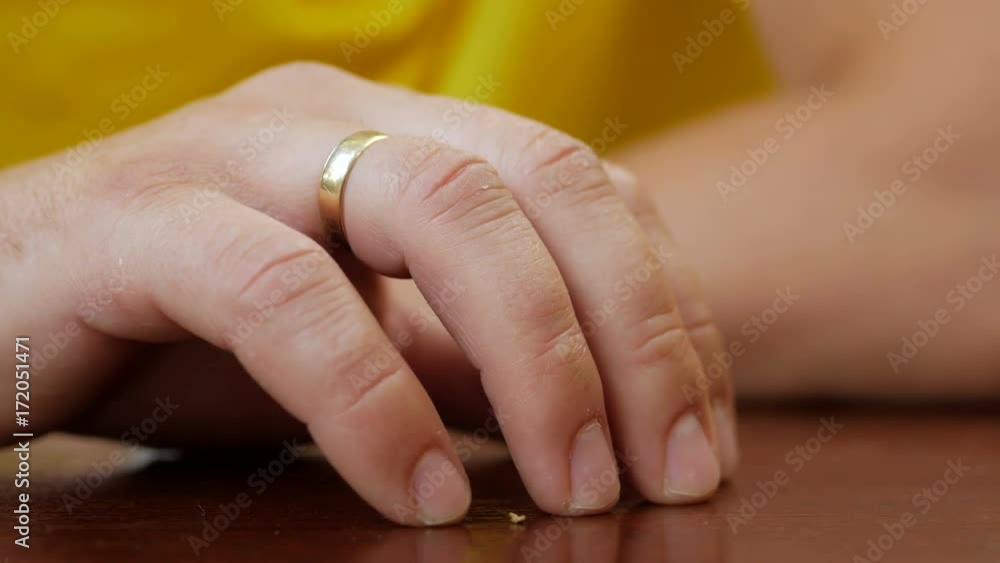 Tired man waiting in cafe. Impatient hand finger tapping closeup on wooden desk. Nervous movement. Young man taps his fingers on a table in utter boredom Tired man waiting in cafe. Impatient hand finger tapping closeup on wooden desk. Nervous movement. Young man taps his fingers on a table in utter boredom