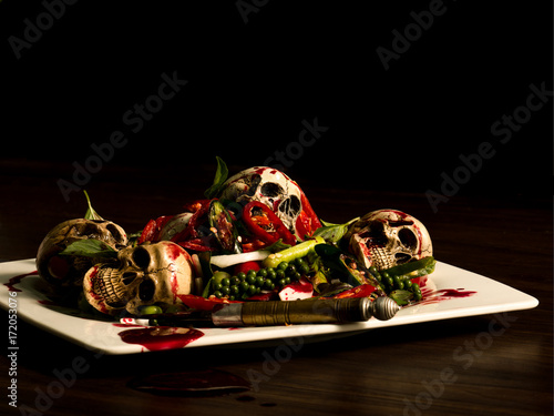 A dish of spicy skulls with herb to be a meal for wizard, witch in the party of Halloween celebration. © Mongkolchon