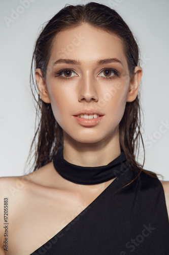 Portrait of beautyful woman in black dress isolated wet hair