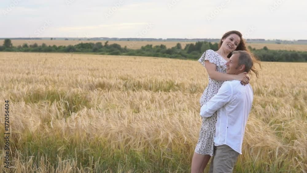 Romantic date on a wheat field, love couple hugs Romantic date on a wheat field, love couple hugs