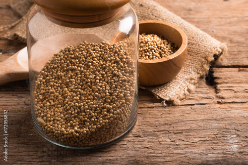 Coriander seeds on a wood background