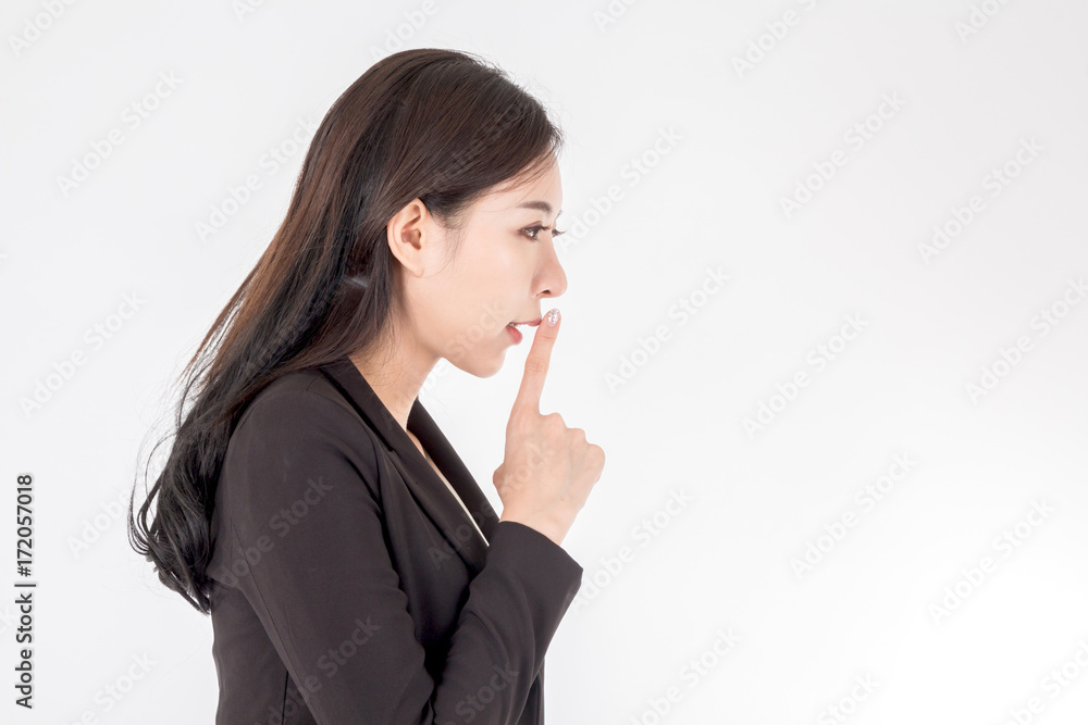 Business woman quiet gesture with finger on white background Business woman quiet gesture with finger on white background