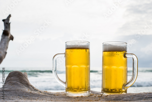 Glass of beer on a beach