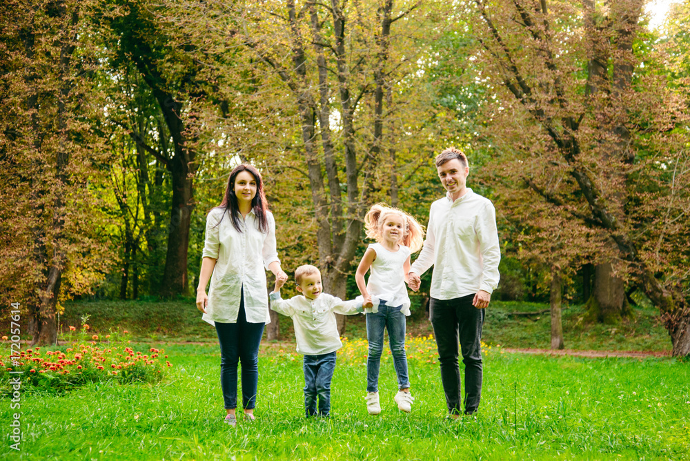 happy family running in city park