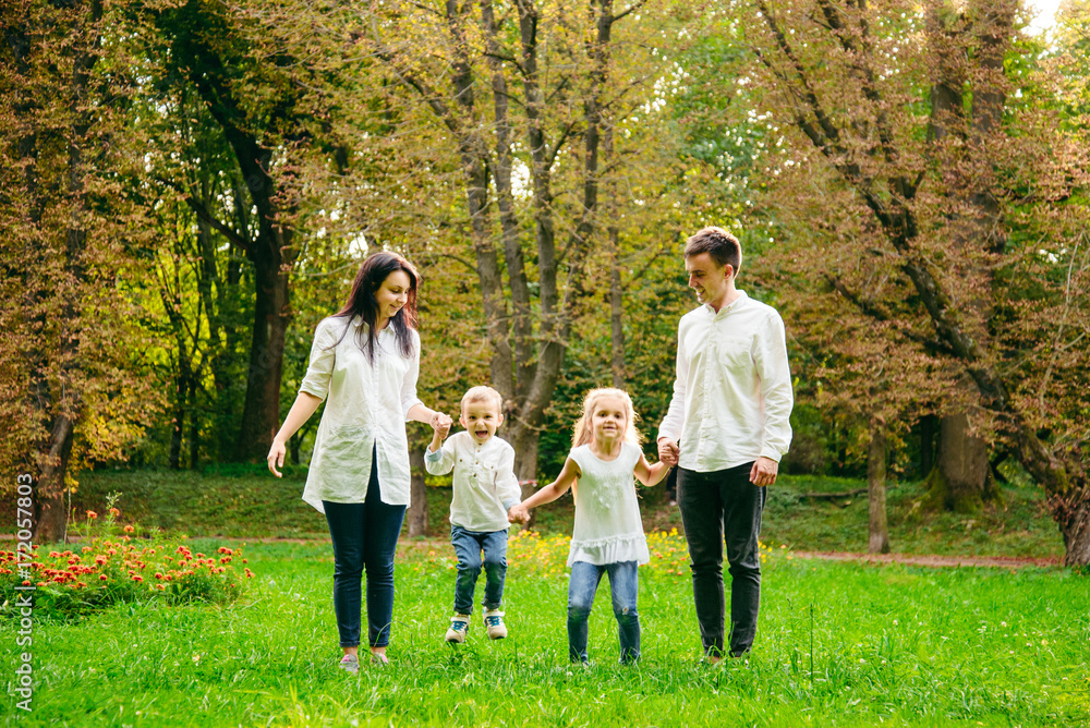 Fototapeta premium happy family running in city park