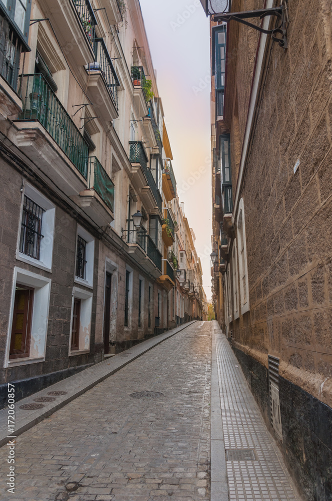 Narrow old alley in Cadiz , Spain