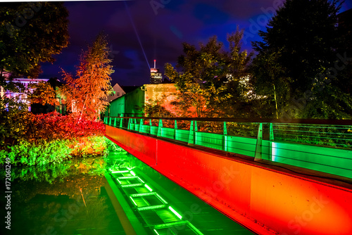 Illuminated bridge with trees during light festival photo