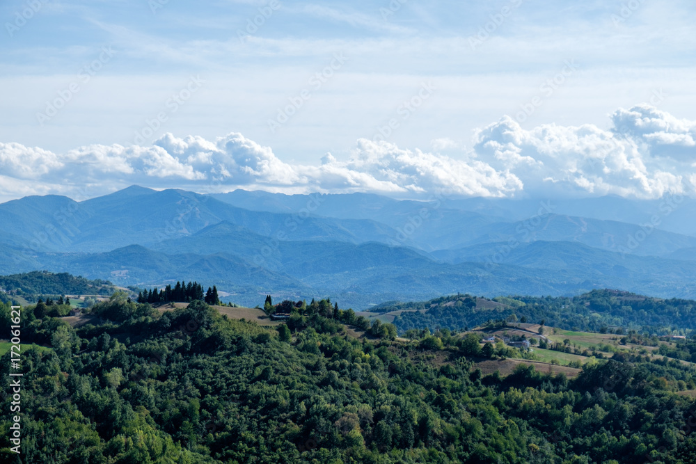View of Langhe hills and of italian Alps from the top of the medieval tower of Murazzano, Piedmont, Italy.