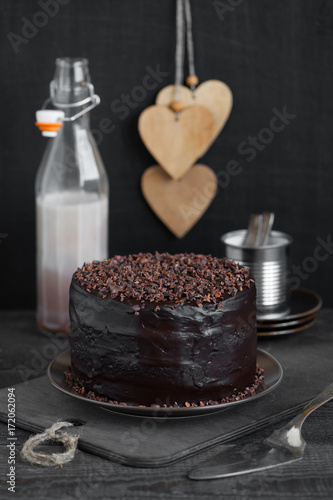 Homemade chocolate cake on the rough wooden table