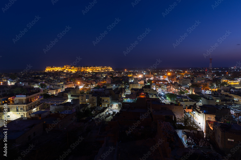 Jaisalmer cityscape at dusk. The majestic fort dominating the city. Scenic travel destination and famous tourist attraction in the Thar desert, Rajasthan, India.