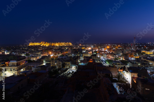 Jaisalmer cityscape at dusk. The majestic fort dominating the city. Scenic travel destination and famous tourist attraction in the Thar desert, Rajasthan, India.