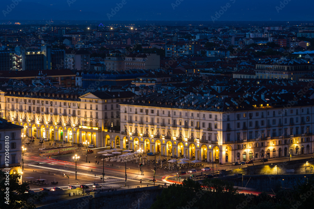 Cityscape of Torino (Turin, Italy) at night with details of large square (Piazza Vittorio Veneto), streets and city lights.