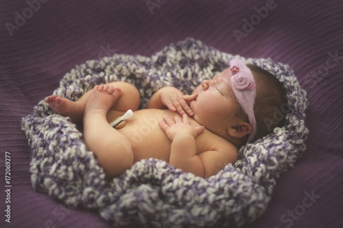 newborn baby sleeping on purple knitted ,toning