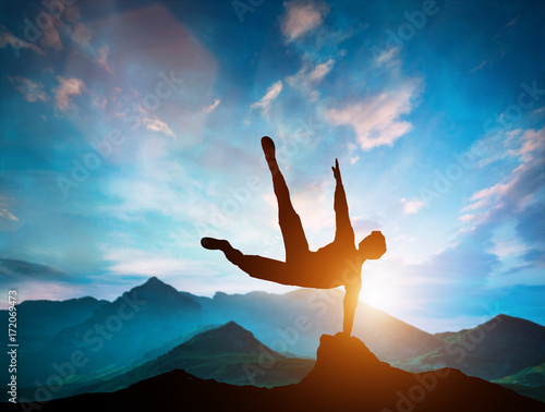 Man jumping over rocks in parkour action in mountains.