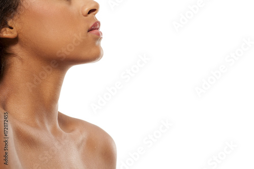 Profile of dark skinned woman's chin, neck, and naked shoulders