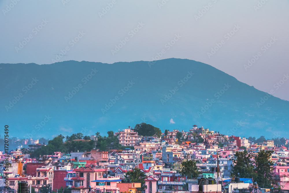 Colourful town with high mountains as backdrop