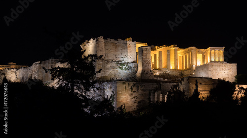 Close-up side view of the acropolis at night