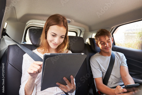 Teenage Children Using Digital Devices On Family Road Trip © Monkey Business