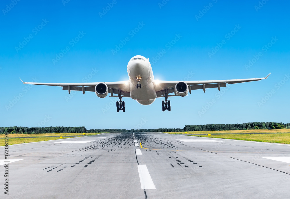 Obraz premium Passenger large airplane fly over the runway in good weather