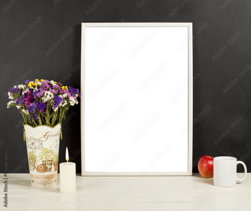 Silver frame mockup with field flowers in vase, apple, mug and candle Silver frame mockup with field flowers in vase, apple, mug and candle