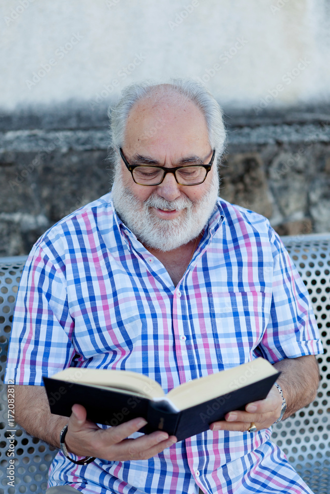 Retired man reading a book Retired man reading a book