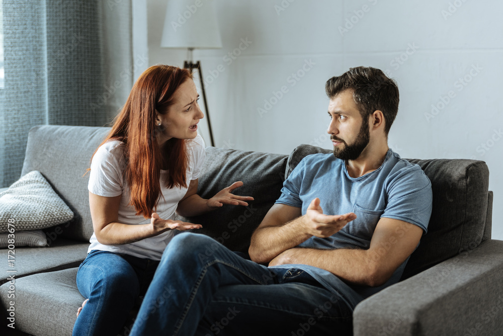 Unhappy emotional woman shouting at her boyfriend Unhappy emotional woman shouting at her boyfriend