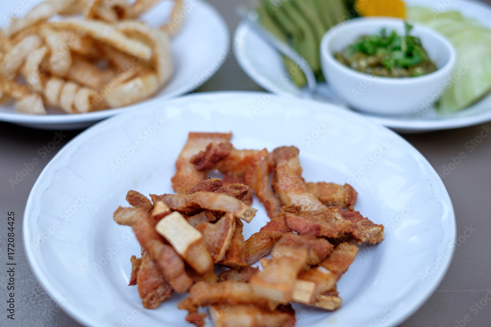 Fried pork belly / fried streaky pork, snack made of deep fried pork meat with fatty skin. Famous food in Chiang Mai in Northern Thailand. Fried pork belly / fried streaky pork, snack made of deep fried pork meat with fatty skin. Famous food in Chiang Mai in Northern Thailand.