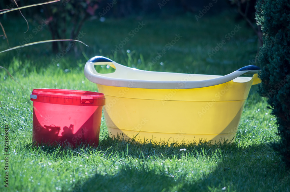 Red Bucket and Yellow Bowl on Grass in Piechowice, Poland Red Bucket and Yellow Bowl on Grass in Piechowice, Poland