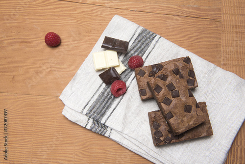 Chocolate brownie slices with raspberries and pieces of chocolate 
