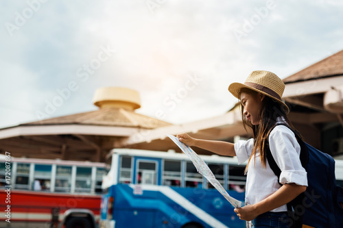 happy female tourist on map to Bus station vacation.Travel concept.