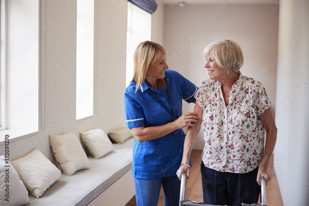 Fototapeta premium Nurse helping senior woman use a walking frame