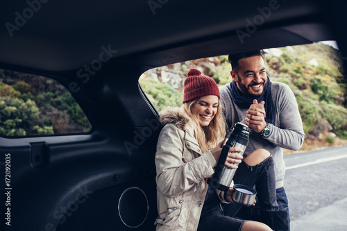 Couple having coffee break during road trip
