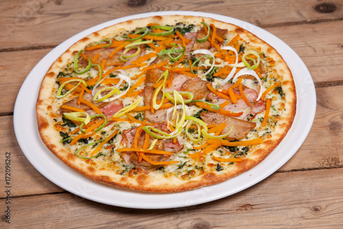 seasonal autumn pizza with onion vegetables carrot pumpkin and bacon