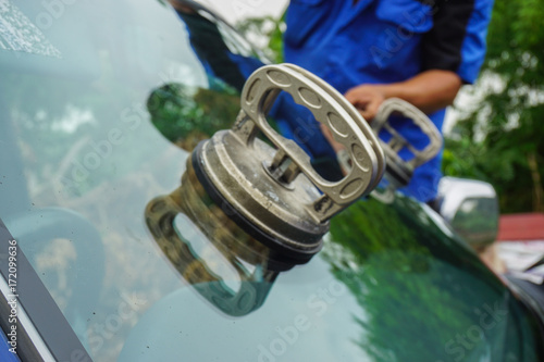 repairing windshield replace windscreen wiper tools fix crack broken front window glass car vehicle services by Glazier. Maintenance repair, replace windshield, windscreen car wiper concept. 