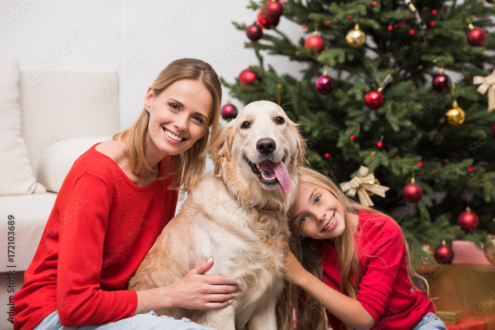 mother and daughter embracing dog mother and daughter embracing dog