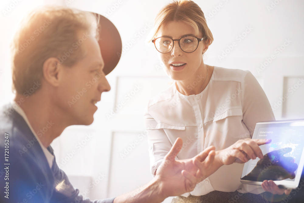 Positive delighted woman pointing at the tablet screen Positive delighted woman pointing at the tablet screen