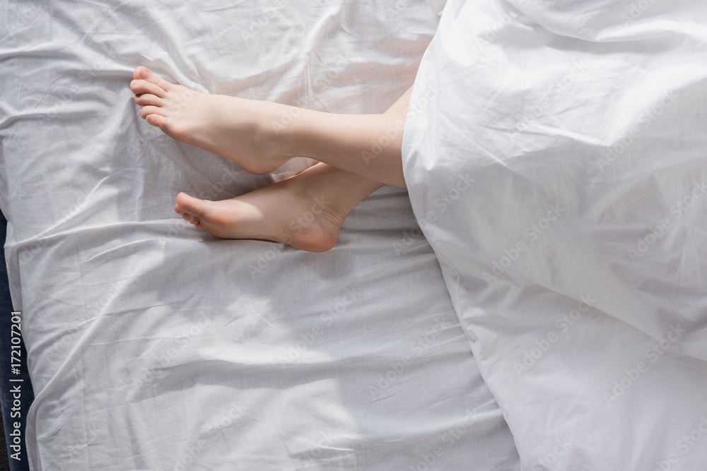 female feet stretching out of blanket female feet stretching out of blanket