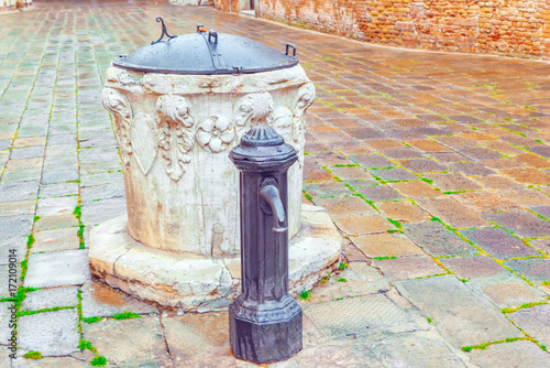 Water intake facilities medieval Venetian wells in the city squares. Venice.  Italy.